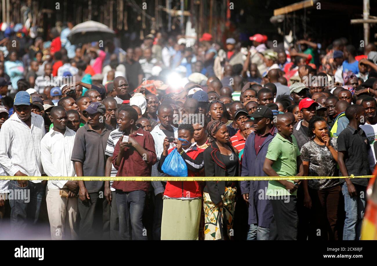 Second-hand clothes traders gather at the scene of a twin explosion at the Gikomba open-air market in Kenya's capital Nairobi May 16, 2014. At least four people were killed on Friday in two explosions in Nairobi, the country's National Disaster Operations Centre (NDOC) said. REUTERS/Thomas Mukoya (KENYA - Tags: CIVIL UNREST CRIME LAW) Stock Photo