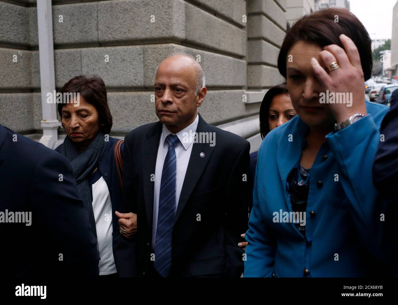 Prakesh Dewani (C), Shrien Dewani's father, arrives at the High Court in Cape Town with family members, June 20, 2014. A South African judge on Friday set Oct. 6 as the start date for the murder trial of British businessman Shrien Dewani who is accused of planning the killing of his bride in a staged car-jacking while on honeymoon in Cape Town in 2010. REUTERS/Mike Hutchings (SOUTH AFRICA - Tags: CRIME LAW) Stock Photo