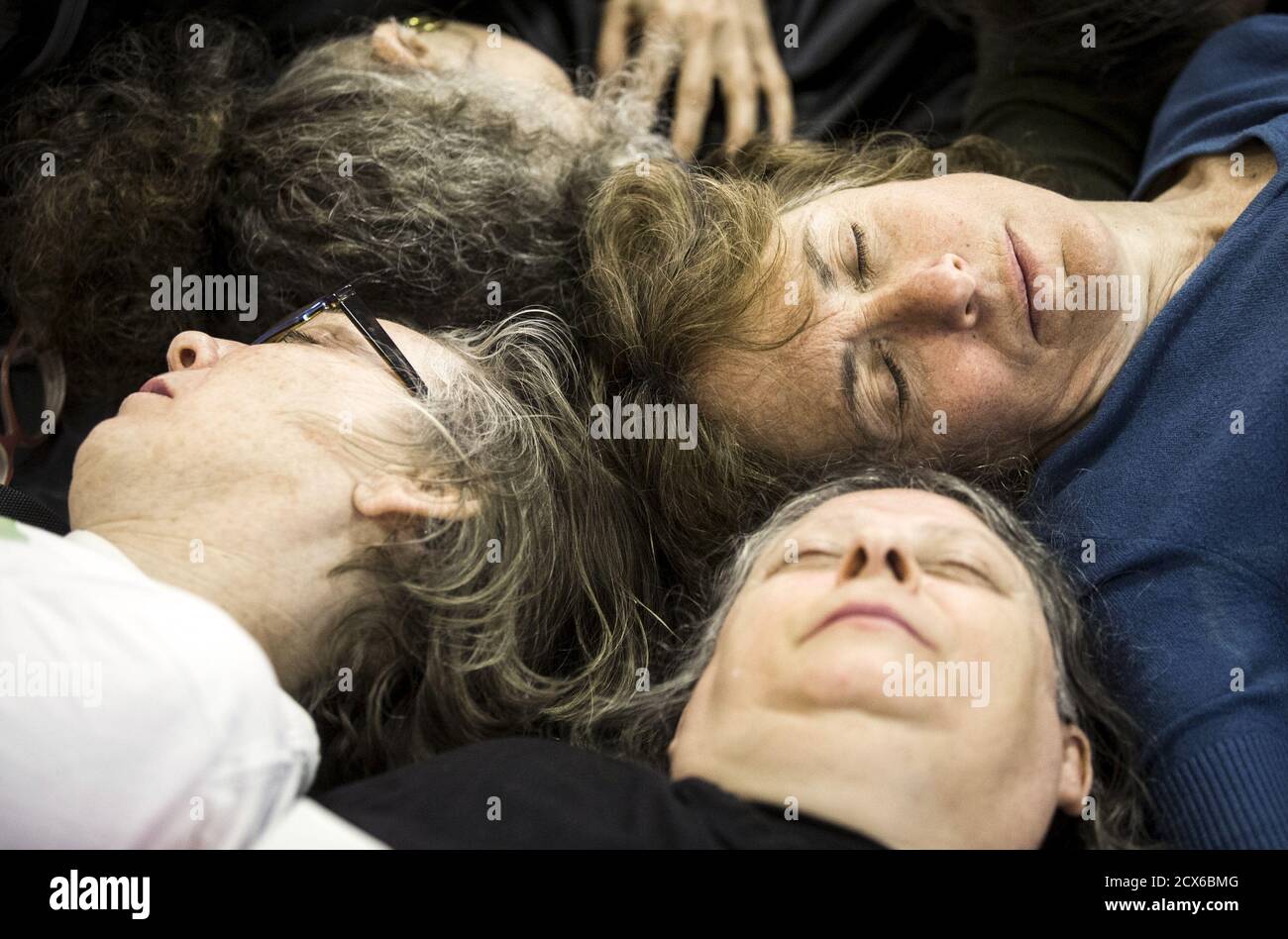 Protesters from the "The Toronto No Line 9 Network" perform a "die-in" to demonstrate what they say are the possible effects if the Enbridge operated "Line 9" petroleum pipeline, which runs under the Finch subway station, ruptured, in Toronto, June 29, 2015. Enbridge has been seeking permission to reverse the flow of the pipeline that runs from southern Ontario to Montreal. The National Energy Board has ordered Enbridge to conduct hydrostatic testing before they can proceed with the plan, according to local media reports. REUTERS/Mark Blinch Stock Photo