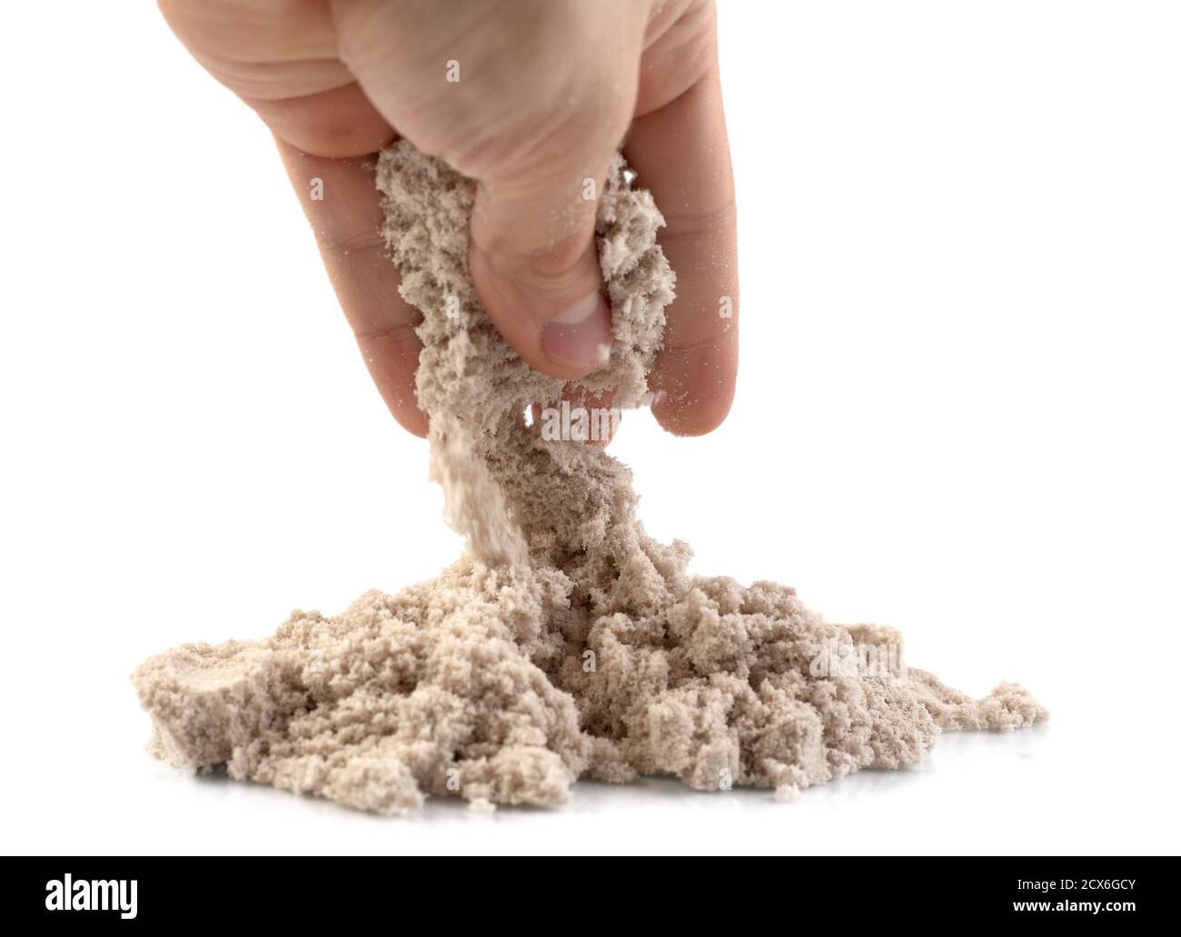 Hand and kinetic sand isolated on white background Stock Photo - Alamy