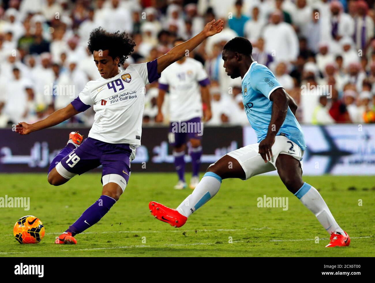 Manchester City's Micah Richards (R) fights for the ball with Al Ain FC's  Adel Gamal during their friendly soccer match at Hazza Bin Zayed Stadium in  Al Ain May 15, 2014. REUTERS/Ahmed