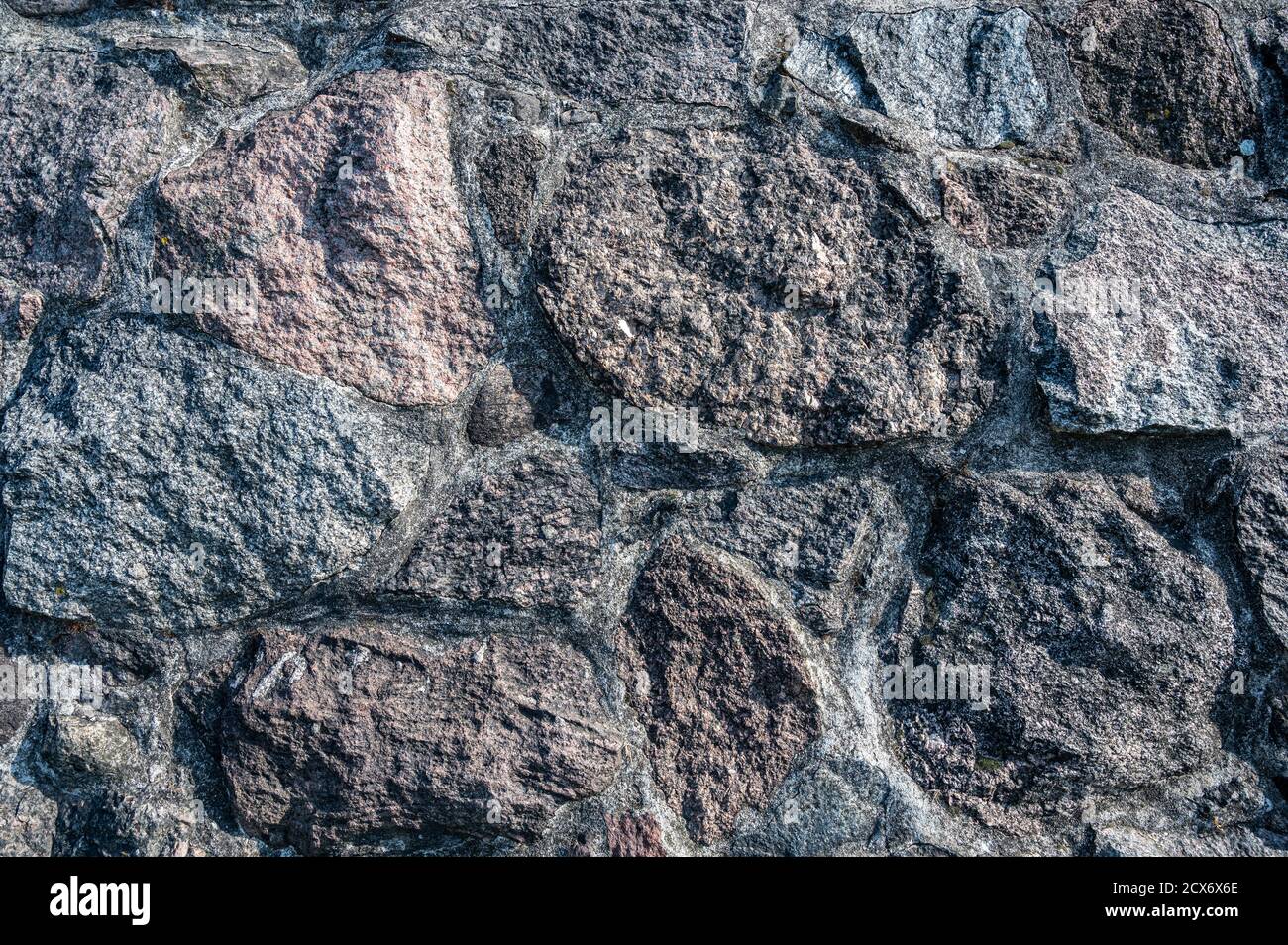 Background of the wall of large granite textured stones, horizontal view Stock Photo