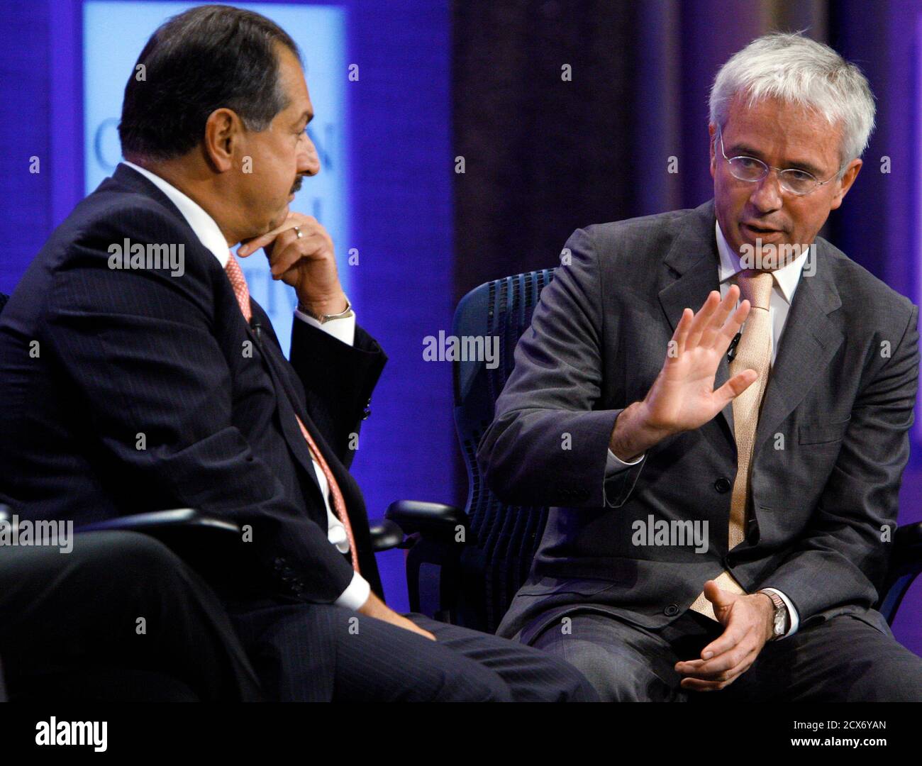 Andrew Liveris (L), Chairman and Chief Executive Officer of The Dow Chemical Company, listens as Peter Sands, Group Chief Executive for Standard Chartered Bank, speaks with television reporter Maria Bartiromo of CNBC (not pictured) during the taping of a program titled "Meeting of the Minds," at the Clinton Global Initiative in New York September 22, 2010. REUTERS/Chip East (UNITED STATES - Tags: POLITICS BUSINESS SOCIETY) Stock Photo