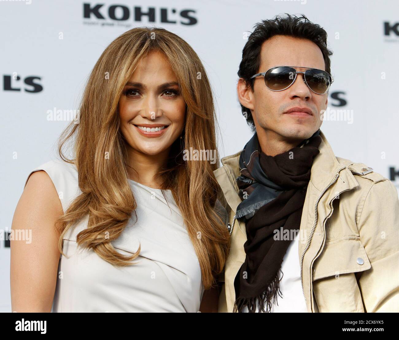 Jennifer Lopez (L) and her husband Marc Anthony pose at a news conference to announce 'The Jennifer Lopez and Marc Anthony' collections in partnership with Kohl's department stores at The London West Hollywood hotel in West Hollywood, California, November 18, 2010. Kohl's will be the exclusive provider of the contemporary lifestyle brands in the U.S. and it will be available nationwide in Fall 2011 beginning with women's and men's apparel and accessories. REUTERS/Danny Moloshok (UNITED STATES - Tags: ENTERTAINMENT FASHION BUSINESS) Stock Photo