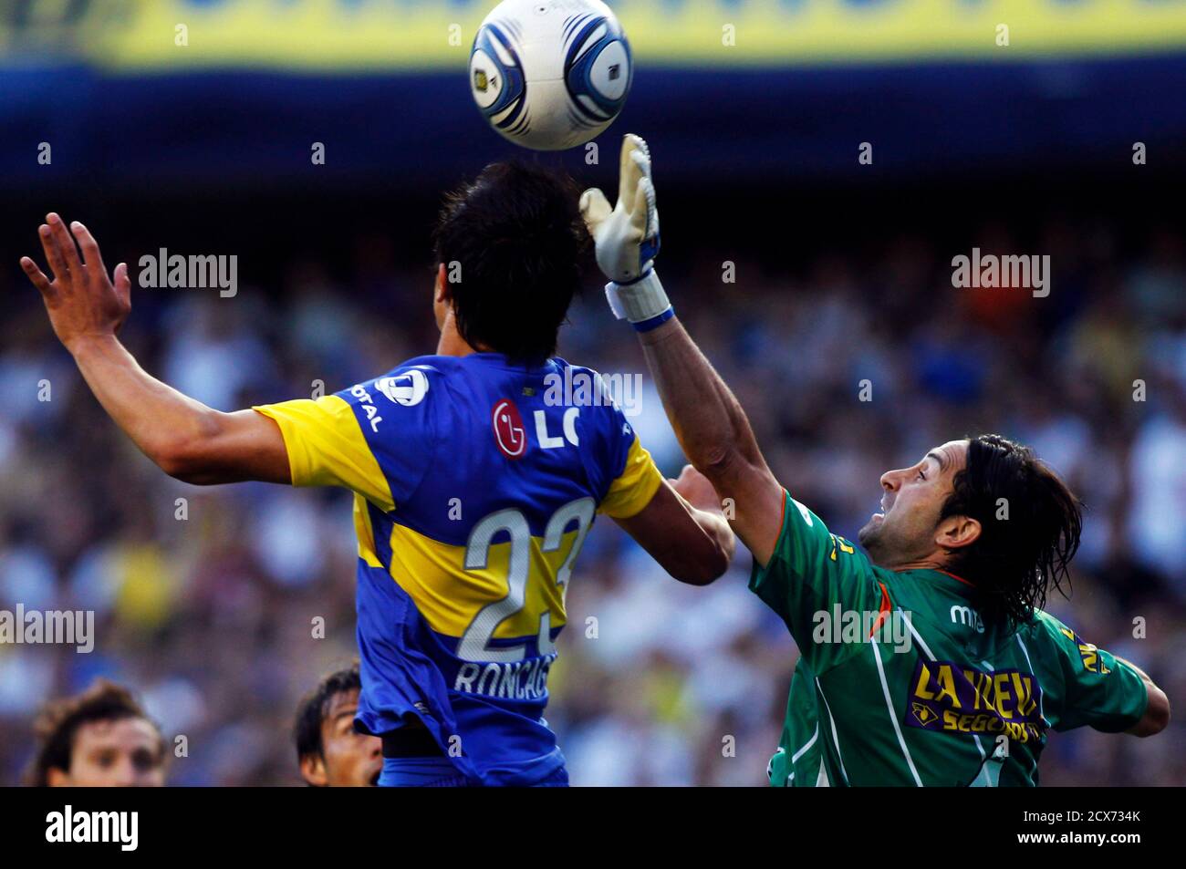 Boca Juniors Facundo Roncaglia L Fights For The Ball With Banfield S Goalkeeper Cristian Lucchetti During Their Argentine First Division Soccer Match In Buenos Aires December 4 2011 Boca Juniors Won The Argentine