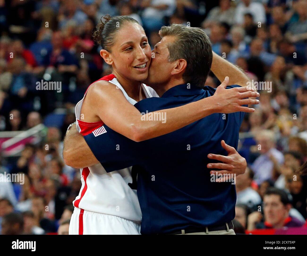 The U.S. head coach Geno Auriemma and player Diana Taurasi celebrate  victory against France after their women's gold medal basketball match at  the North Greenwich Arena during the London 2012 Olympic Games