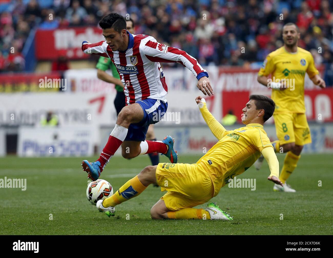 Atletico Madrid's Raul Jimenez (L) and Getafe's Emiliano Velazquez fight  for the ball during their Spanish