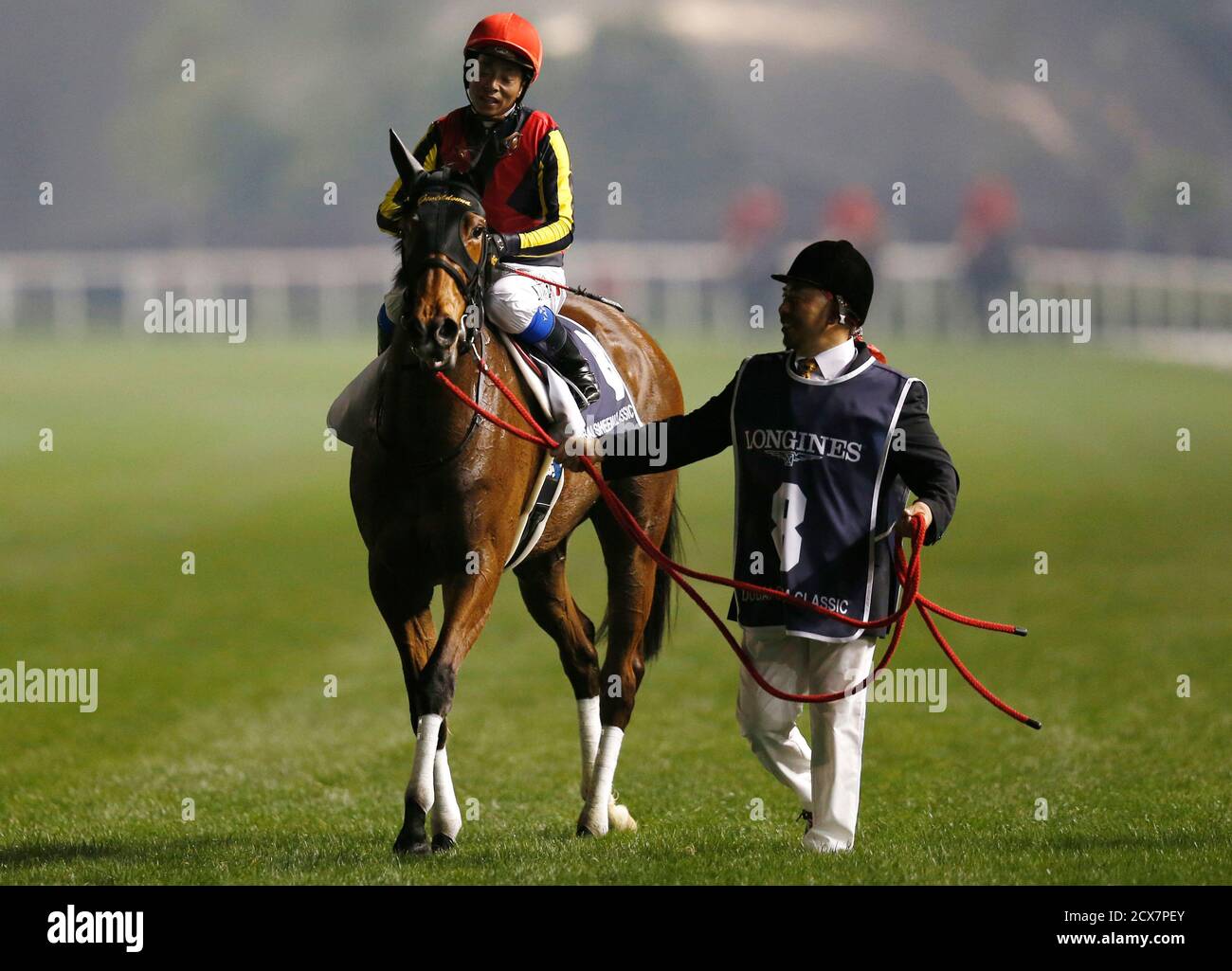 Yasunari Iwata, riding Gentildonna of Japan, returns after the eighth race 'Dubai Sheema Classic' during the Dubai World Cup at the Meydan Racecourse in Dubai March 30, 2013. REUTERS/Ahmed Jadallah (UNITED ARAB EMIRATES - Tags: SPORT HORSE RACING) Stock Photo