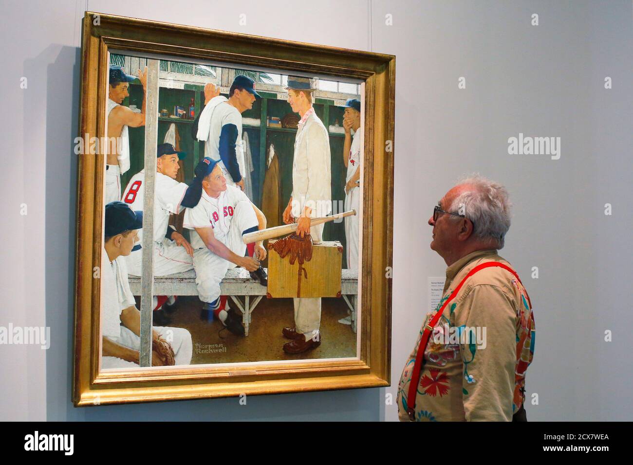 Peter Rockwell, son of painter Norman Rockwell, looks at his father's 1957 painting 'The Rookie (Red Sox Locker Room)' on display at the Museum of Fine Arts, Boston for six days in Boston, Massachusetts April 29, 2014, before being offered at auction at Christie's May 22. The painting, which appeared on the cover of the March 2, 1957 'Saturday Evening Post,' includes former Boston Red Sox players Ted Williams (top center), Jackie Jensen (bottom center) and Bill Goodman (R) as well as local high school student Sherman Safford who Rockwell asked to pose as the Rookie.  Christies estimates the va Stock Photo