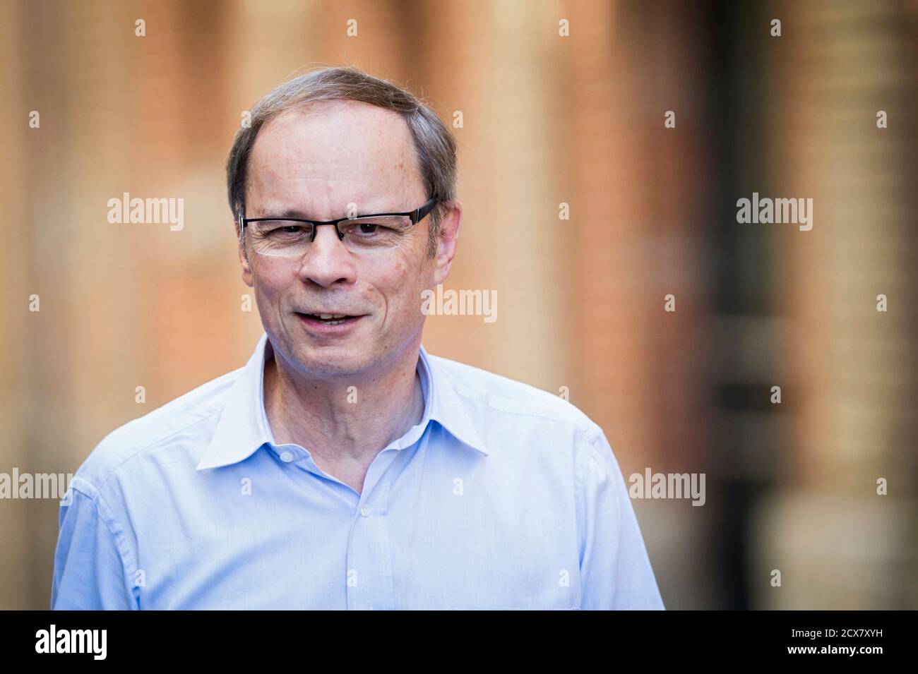 French economist Jean Tirole poses before a news conference at the Toulouse  School of Economics in Toulouse October 13, 2014. French economist Jean  Tirole won the 2014 economics Nobel Prize for his