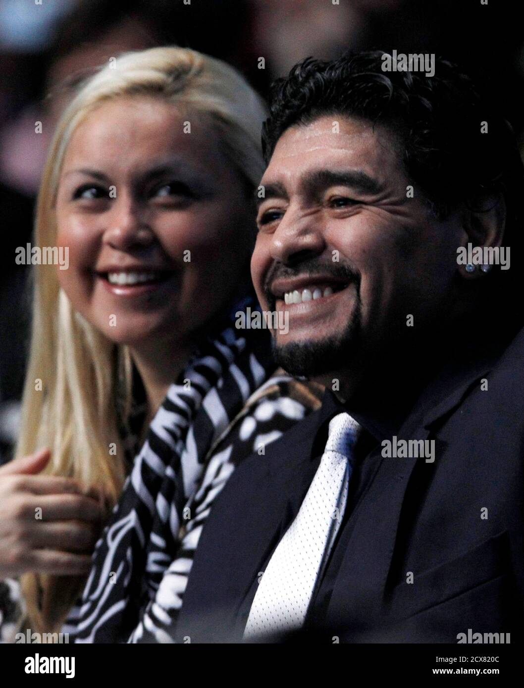 Former Argentine soccer star Diego Maradona and Veronica Ojeda watch the  finals match between Spain's Rafael Nadal and Switzerland's Roger Federer  at the ATP World Tour Finals in London November 28, 2010.