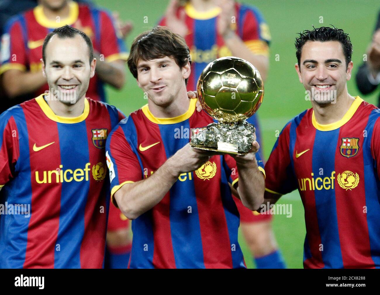 Barcelona's Lionel Messi poses with his Ballon d'Or trophy, the World  Player of the Year award, next to his teammates Andres Iniesta (L) and Xavi  Hernandez before their Spanish King's Cup soccer