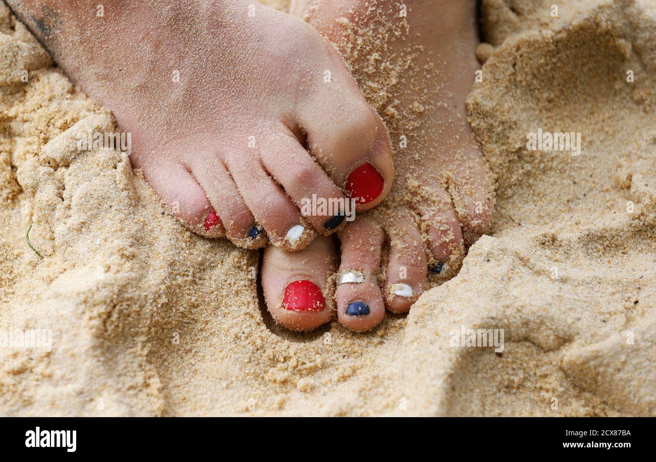 Britain's beach volleyball player Shauna Mullin's red, blue and white painted toenails are seen during a training session at the London 2012 Olympics beach volleyball venue in central London July 19, 2012. REUTERS/Suzanne Plunkett (BRITAIN - Tags: SPORT OLYMPICS SOCIETY VOLLEYBALL) Stock Photo