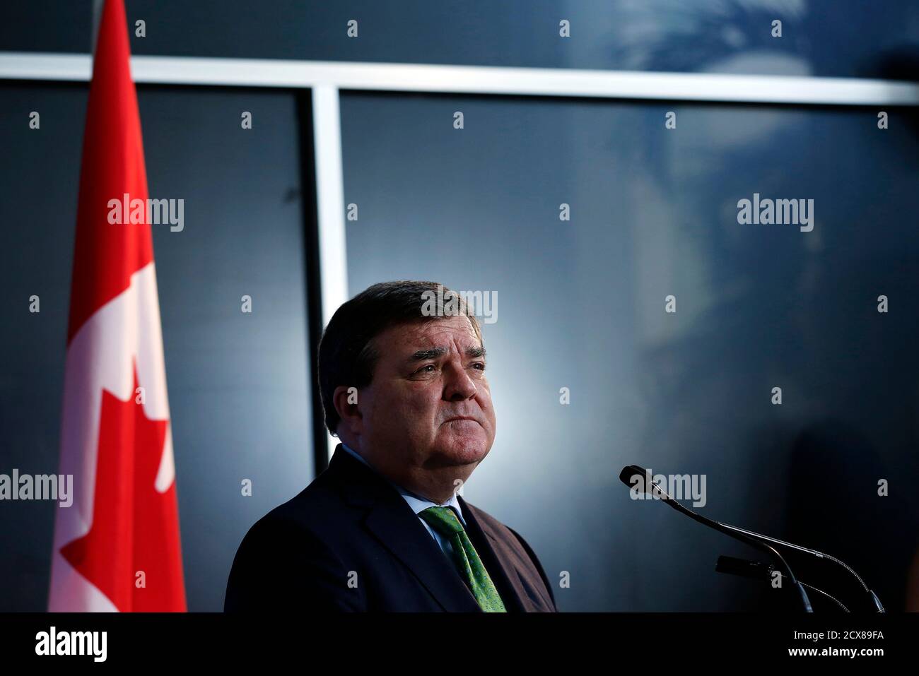Canada's Finance Minister Jim Flaherty listens to a question during a news conference in Ottawa March 1, 2013. The slowing Canadian economy means the government will have lower revenues than it initially forecast as it draws up the next budget, which is due soon, Flaherty said on Friday. REUTERS/Chris Wattie (CANADA - Tags: POLITICS BUSINESS) Stock Photo