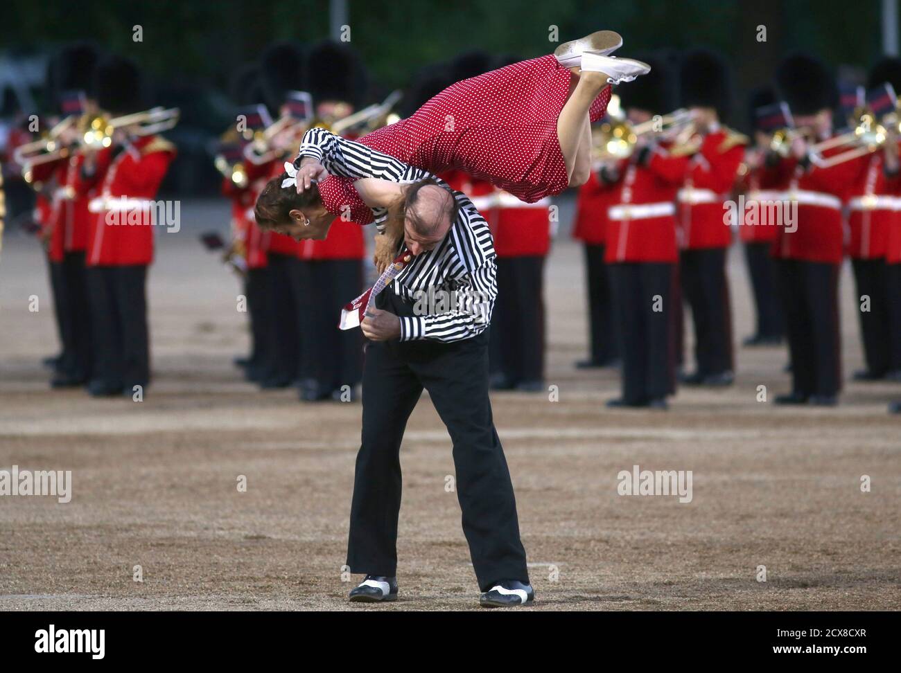 Dancers from the London Swing Dance Society perform alongside members of  the Massed Bands of the Household Division at the Beating Retreat military  pageant at Horse Guards Parade in London June 12,