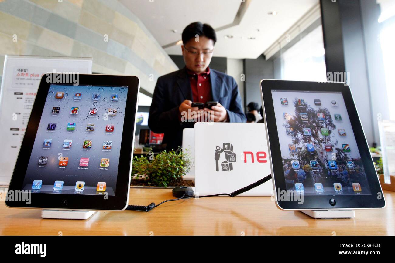 https www alamy com a customer holds a apple inc iphone 4 smartphone on display behind the companys ipad tablets at a registration desk at the headquarters of south korean mobile carrier kt in seoul april 19 2011 apple sued samsung electronics claiming the south korean firms galaxy line of mobile phones and tablets slavishly copies the iphone and ipad according to court papers a move analysts say is aimed at keeping its close rivals at bay samsung said it would respond to the legal action through appropriate legal measures to protect our intellectual property reutersjo yong hak south korea tags image377588075 html