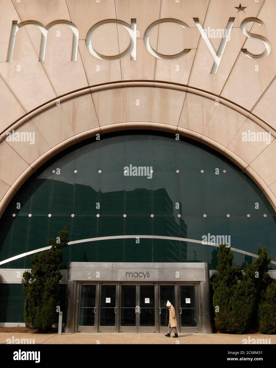 A pedestrian walks by a Macy's store in Arlington, VA ...