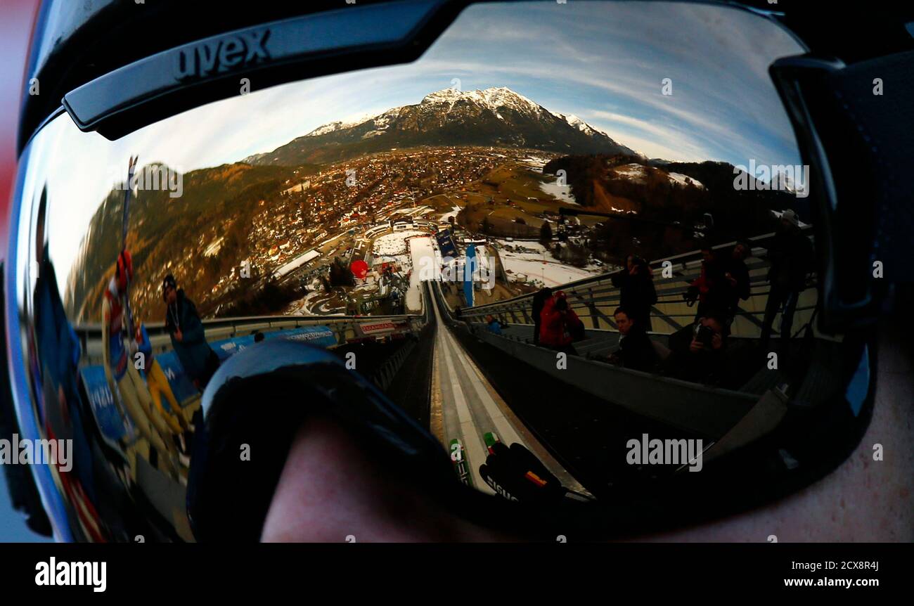 The city of Garmisch-Partenkirchen and the ski stadium is reflected in the  goggles of Germany's Tobias Bogner during the first practice session for  the second jumping of the 61st four-hills ski jumping