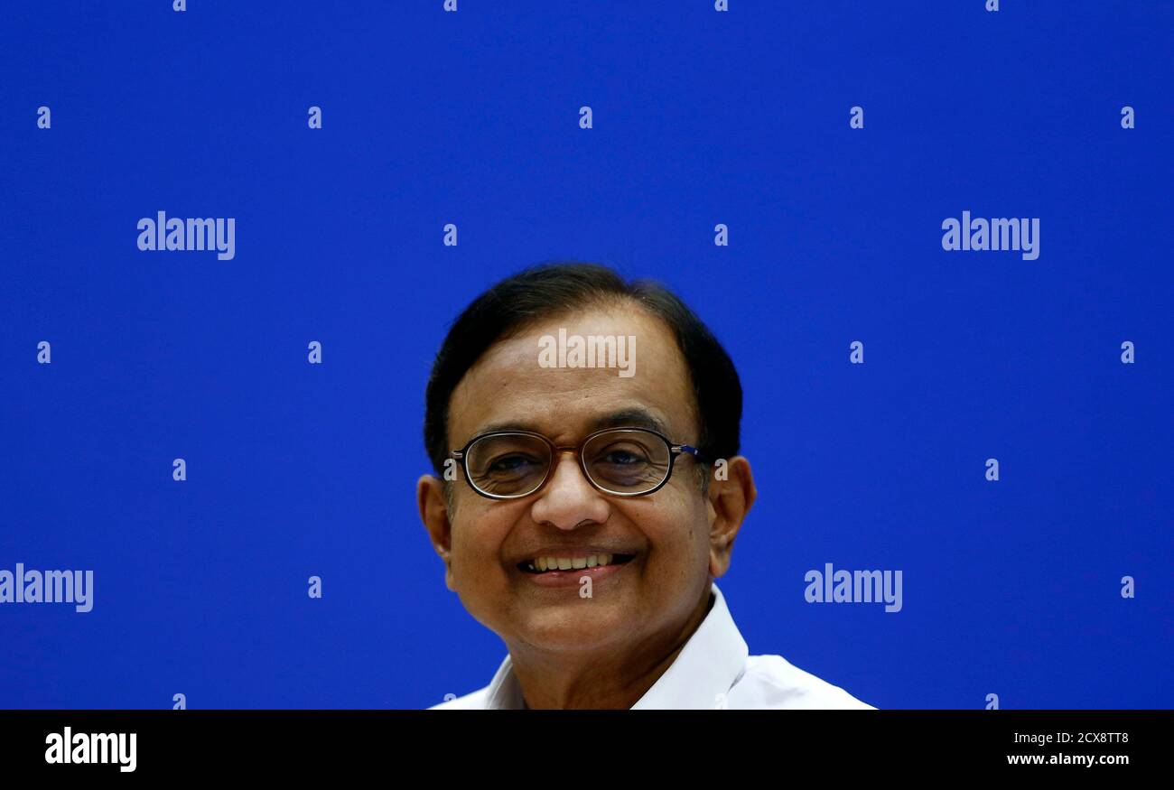 India's Finance Minister Palaniappan Chidambaram smiles during a news conference in New Delhi July 31, 2013. There is scope to cut imports of some non-essential items such as electronic goods that could be produced in India, Chidambaram said on Wednesday. REUTERS/Adnan Abidi (INDIA - Tags: BUSINESS POLITICS HEADSHOT) Stock Photo