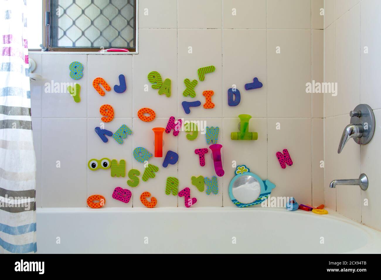 Childs alphabet bath toys in bathroom. Stock Photo