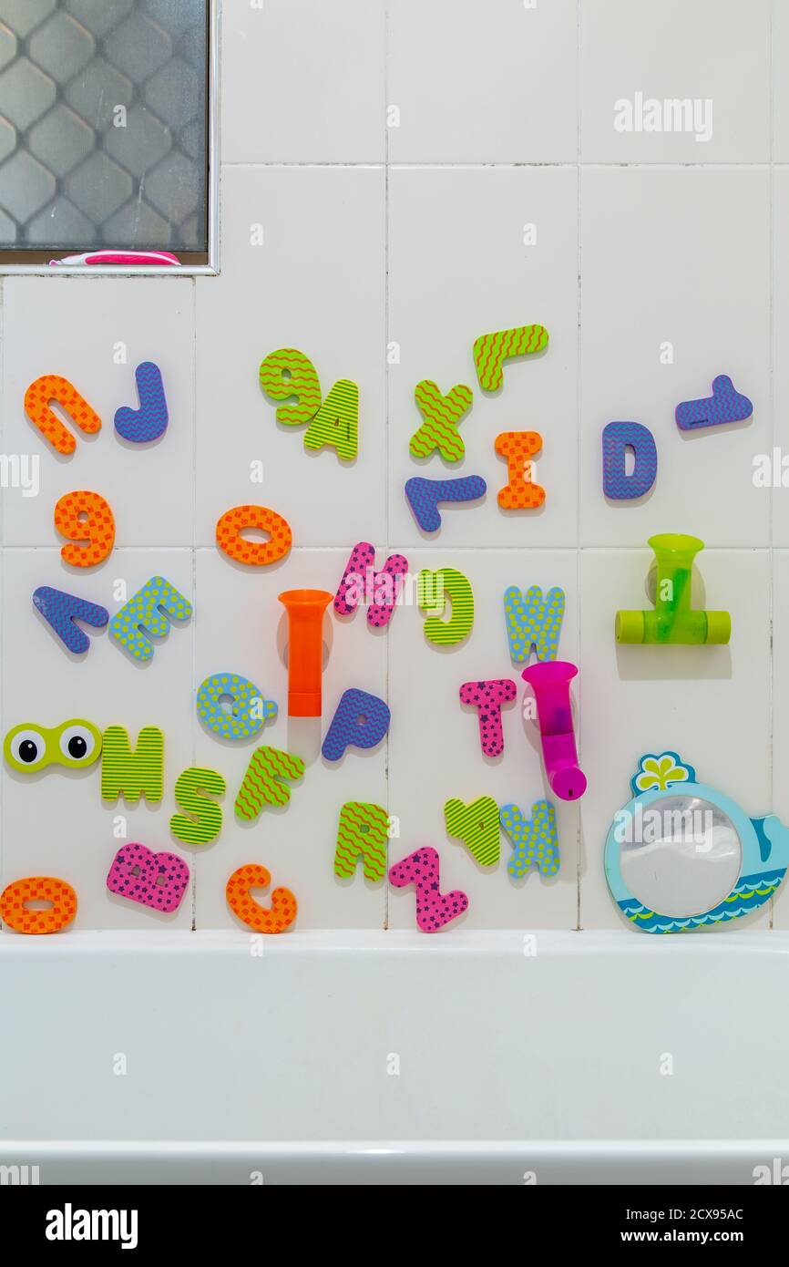 Childs alphabet bath toys in bathroom. Stock Photo