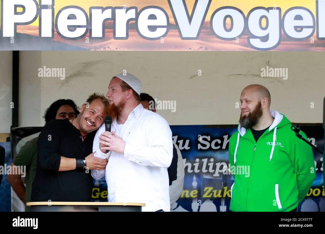 Islamic cleric Pierre Vogel (C) poses with German actor Willi Herren (L)  during a pro-Islam demonstration in Cologne June 9, 2012. REUTERS/Ina  Fassbender (GERMANY - Tags: RELIGION CIVIL UNREST POLITICS ENTERTAINMENT  Stock