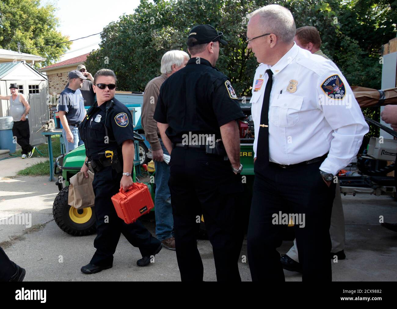 Roseville police officers carry in paper bags the wet soil samples removed from under a concrete driveway in the latest effort to find the remains of Teamsters union leader Jimmy Hoffa, who disappeared in 1975,  in a residential neighborhood of Roseville, Michigan September 28, 2012.    REUTERS/Rebecca Cook  (UNITED STATES - Tags: CRIME LAW) Stock Photo