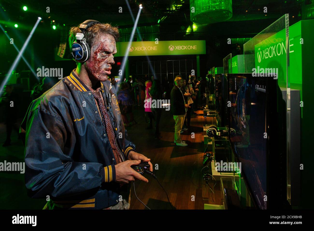 A man dressed as a zombie plays video games on an Xbox One console during a  midnight launch event in New York, November 21, 2013. REUTERS/Lucas Jackson  (UNITED STATES - Tags: ENTERTAINMENT