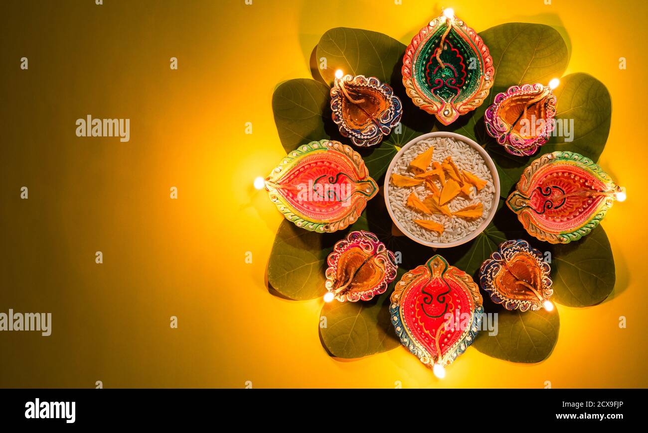 Happy Dussehra. Clay Diya lamps lit during Dussehra with yellow ...