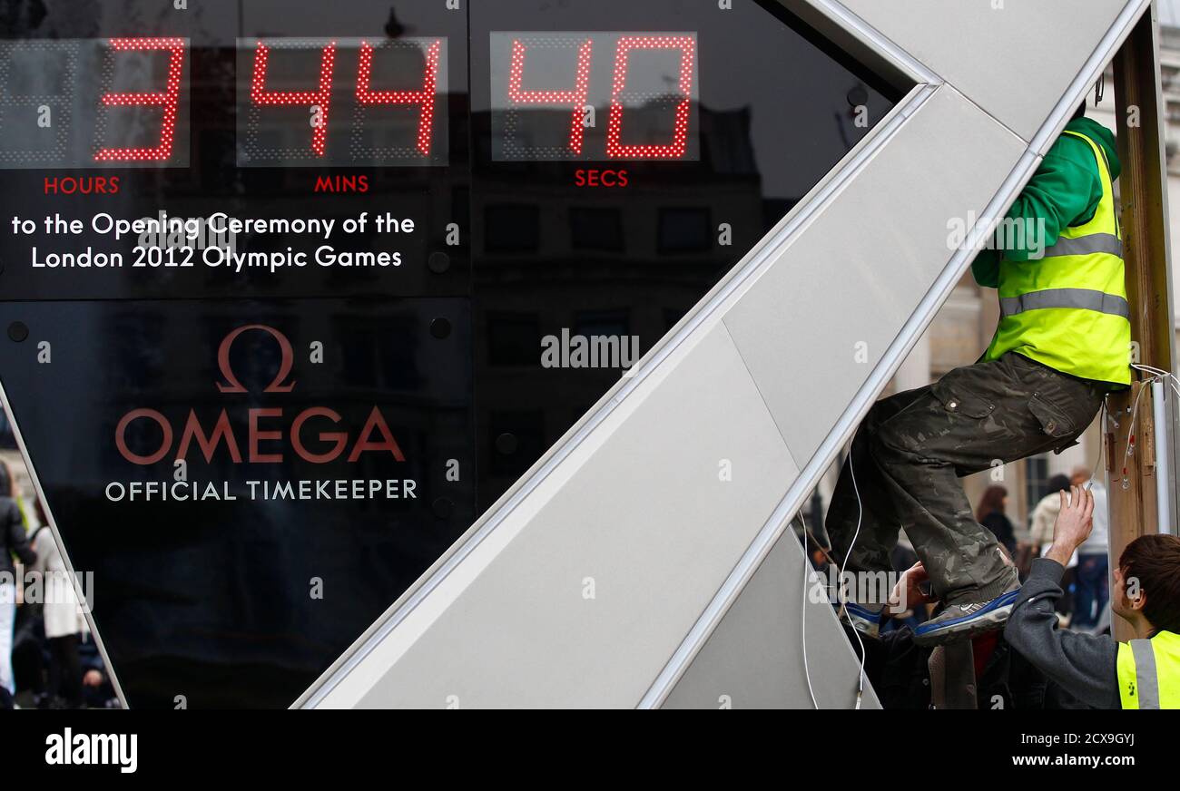 A Technician Climbs Into The Olympic Countdown Clock In Trafalgar Square In Central London March 15 2011 London Olympic Organisers Were Left Red Faced On Tuesday When A Huge Clock In Trafalgar Square