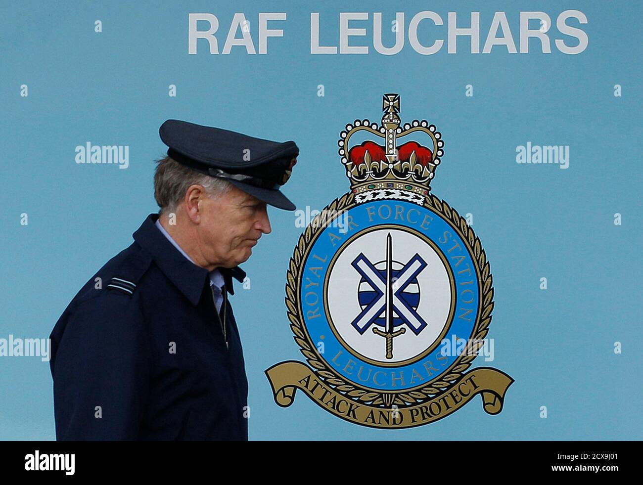 A Royal Air Force Officer Walks Past A Sign At The Main Gate Of Raf  Leuchars Air Base In Fife, Scotland July 18, 2011. The Raf Is To Withdraw  From Leuchars, Leaving