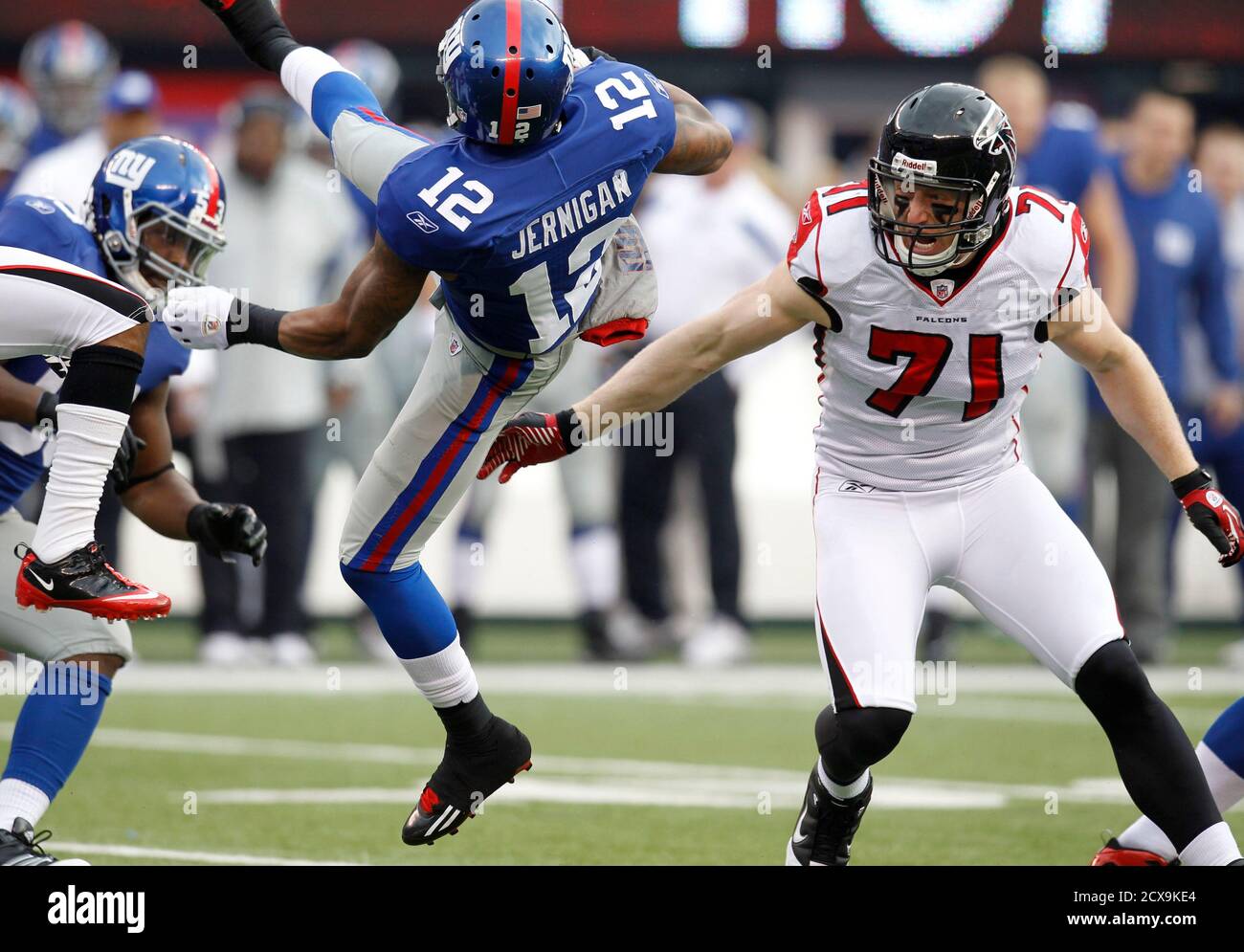 New York Giants wide receiver Jerrel Jernigan (12) is hit by Atlanta Falcons  defensive end Kroy Biermann (71) in the first quarter of their NFL NFC  wildcard playoff football game in East