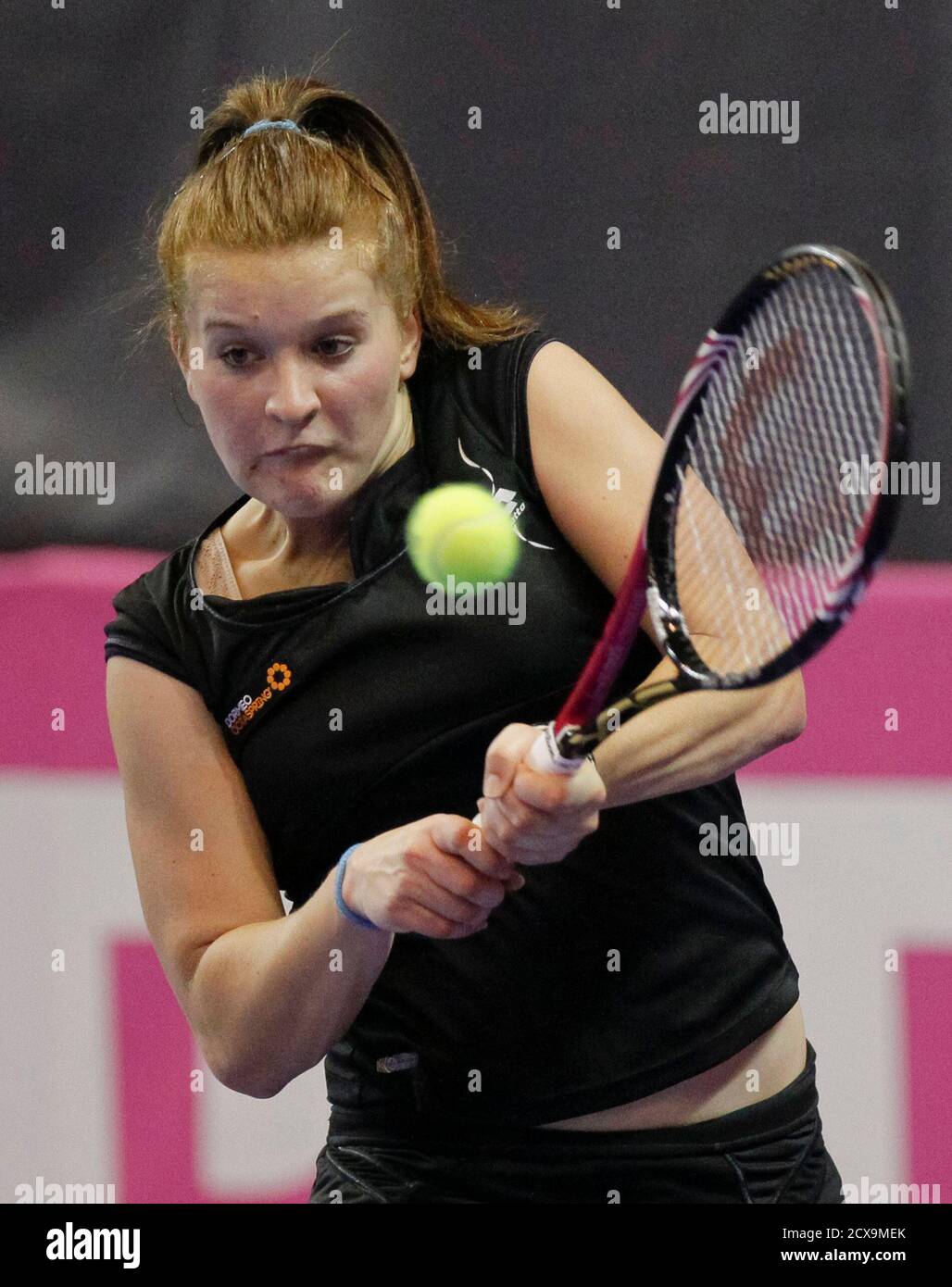 Nastja Kolar of Slovenia hits a return to Pauline Parmentier of France  during their first round singles play-off match at the Fed Cup World Group  2 tennis tournament in Besancon April 21,