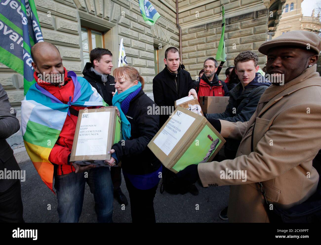 Members of the Referendum Committee and activists deliver boxes with 63,000 signatures to the chancellery in Bern January 17, 2013, for a referendum against the urgent measures of the asylum law revision (dringlichen Massnahmen der Asylgesetzrevision).   REUTERS/Denis Balibouse (SWITZERLAND - Tags: POLITICS) Stock Photo