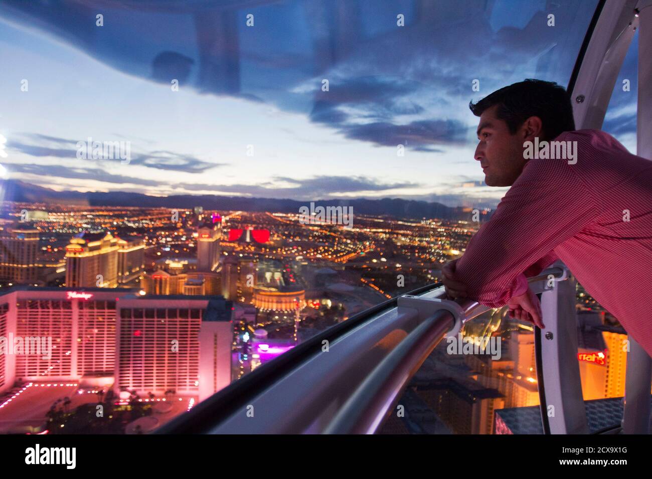 Alejandro Higuera of Mexico rides the 550 foot-tall (167.6 m) High Roller observation wheel, the tallest in the world, in Las Vegas, Nevada April 9, 2014. The wheel is the centerpiece of the $550 million Linq project, a retail, dining and entertainment district by Caesars Entertainment Corp. REUTERS/Las Vegas Sun/Steve Marcus (UNITED STATES - Tags: TRAVEL BUSINESS SOCIETY CITYSCAPE) Stock Photo