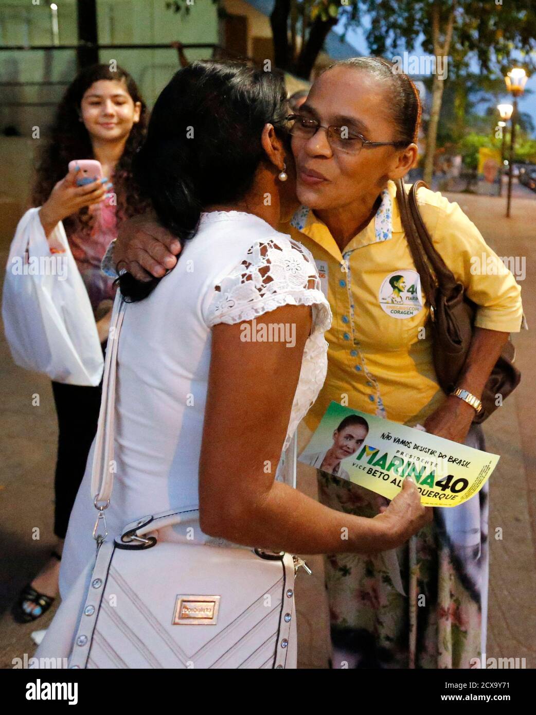 Maria Lucia (R), sister of Brazilian Socialist Party (PSB) presidential candidate Marina Silva, kisses a supporter during a campaign rally in Rio Branco, Acre state October 3, 2014. Brazil will hold its general elections on October 5, to elect the country's National Congress, president, state governors and state legislatures.   REUTERS/Sergio Moraes  (BRAZIL - Tags: POLITICS ELECTIONS) Stock Photo