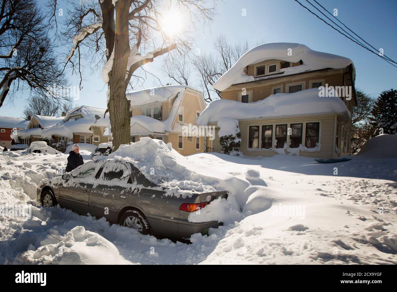 A Man Digs Out His Snow Covered Car In Buffalo New York November 21 2014 Warm