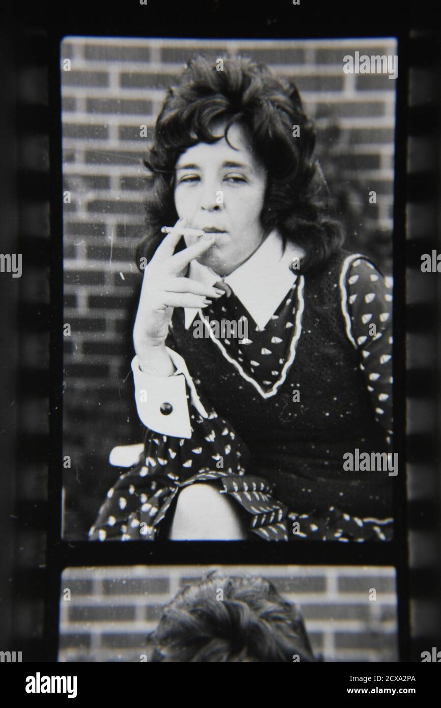 Fine 1970s vintage black and white photography of a woman smoking a