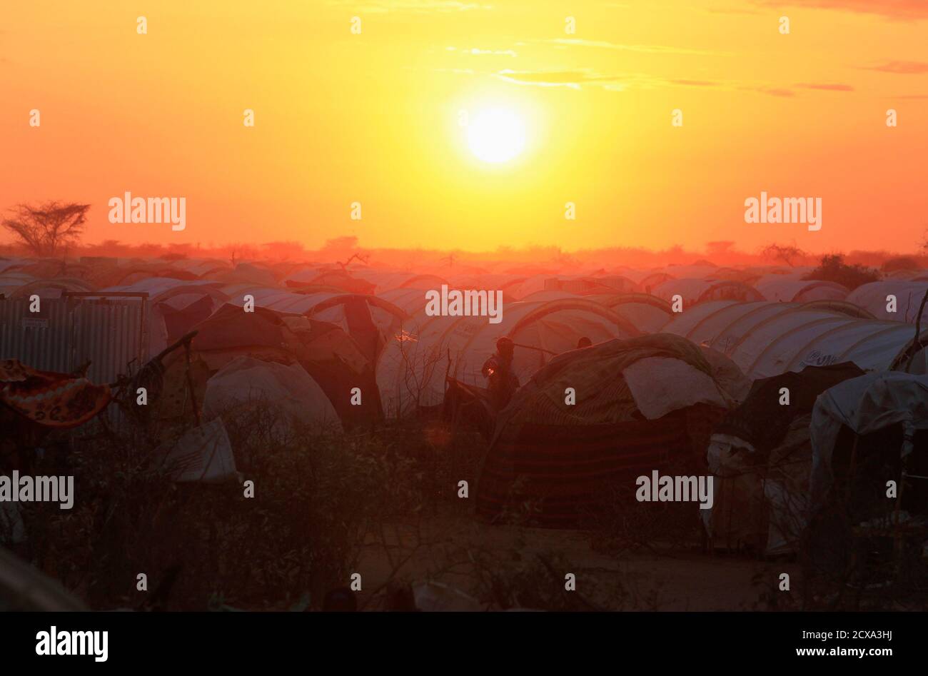 The sun sets over the Ifo extension refugee camp in Dadaab, near the Kenya-Somalia border, July 31, 2011. The whole of drought- and conflict-wracked southern Somalia is heading into famine as the Horn of Africa food crisis deepens, the United Nations said. REUTERS/Thomas Mukoya (KENYA - Tags: SOCIETY CIVIL UNREST DISASTER ENVIRONMENT) Stock Photo