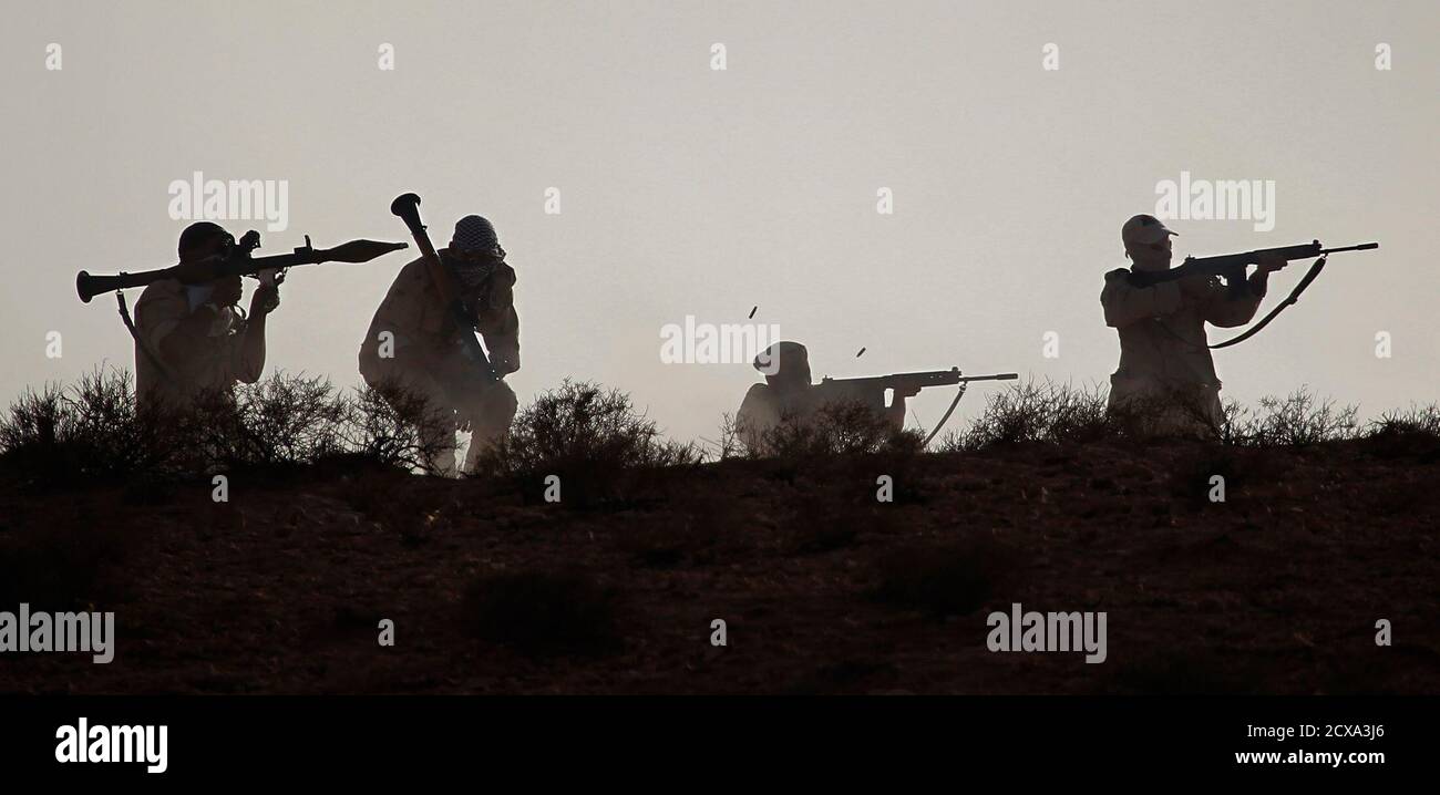 Libyan rebel fighters with the Tripoli Revolutionary Brigade take part in a live firing exercise during a graduation event near Nalut in western Libya, August 6, 2011. REUTERS/Bob Strong (LIBYA - Tags: POLITICS CONFLICT) Stock Photo