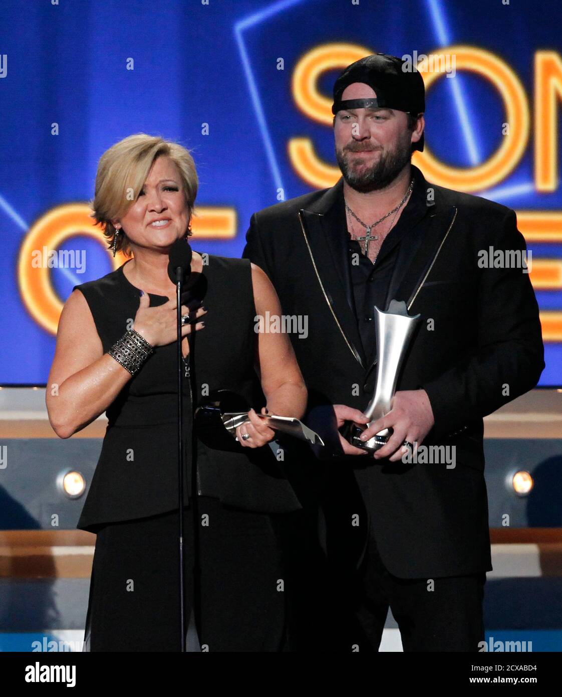 Country singer Lee Brice (R) and songwriter Connie Harrington accept the  award for song of the year for "I Drive Your Truck" at the 49th Annual  Academy of Country Music Awards in