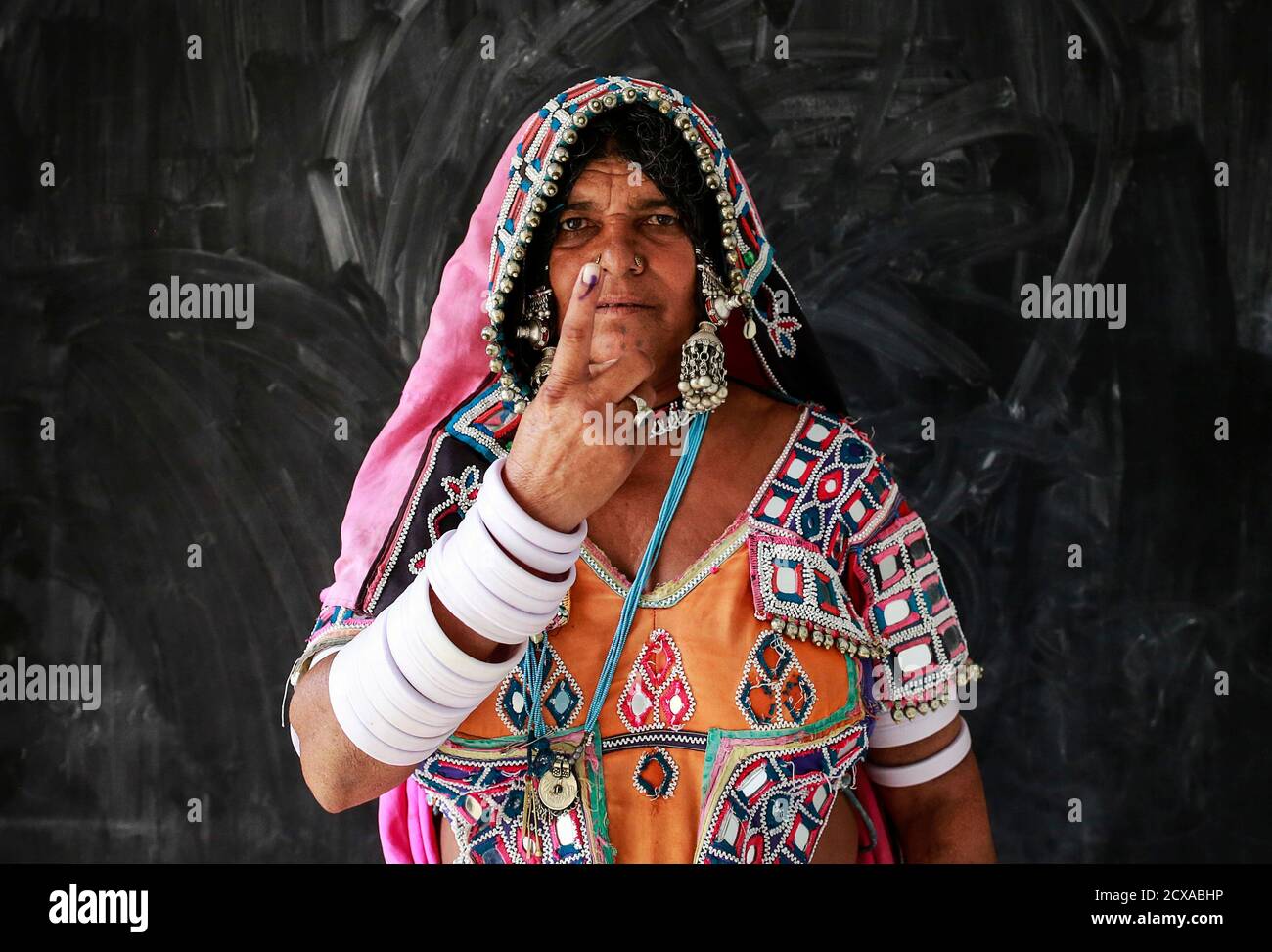 A tribal woman shows her ink-stained finger after voting at a polling centre during the seventh phase of India's general election, in Rangareddy district in the southern Indian state of Andhra Pradesh April 30, 2014. Around 815 million people have registered to vote in the world's biggest election - a number exceeding the population of Europe and a world record - and results of the mammoth exercise, which concludes on May 12, are due on May 16. REUTERS/Danish Siddiqui (INDIA - Tags: ELECTIONS POLITICS TPX IMAGES OF THE DAY) Stock Photo
