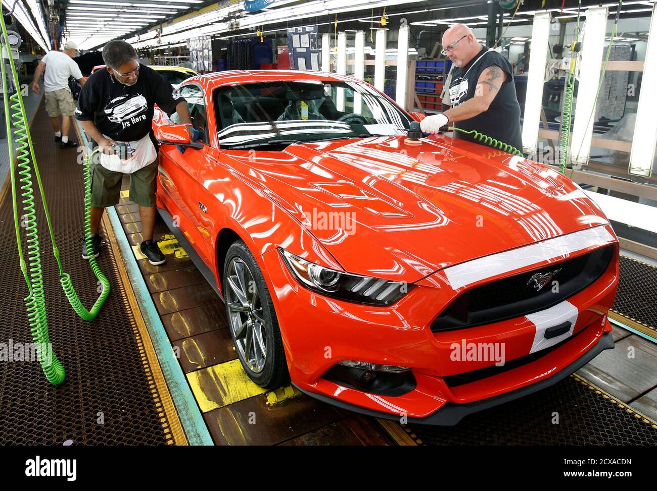 Ford Motor assembly workers Boyd Burton (L) and Wayne Moshier detail a 2015  Ford Mustang on the assembly line at the Flat Rock Assembly Plant in Flat  Rock, Michigan, August 28, 2014.