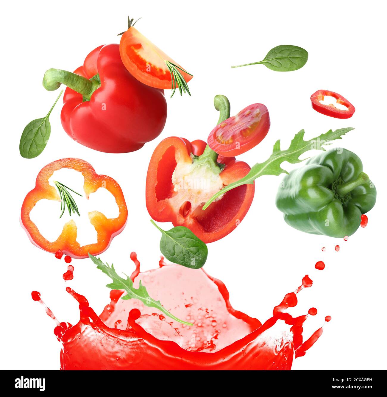 Splash of fresh vegetable juice and flying ingredients on white