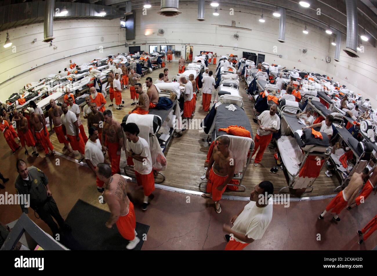Inmates walk around a gymnasium where they are housed due to overcrowding at the California Institution for Men state prison in Chino, California, June 3, 2011. The Supreme Court has ordered California to release more than 30,000 inmates over the next two years or take other steps to ease overcrowding in its prisons to prevent "needless suffering and death." California's 33 adult prisons were designed to hold about 80,000 inmates and now have about 145,000. The U.S. has more than 2 million people in state and local prisons. It has long had the highest incarceration rate in the world. REUTERS/L Stock Photo
