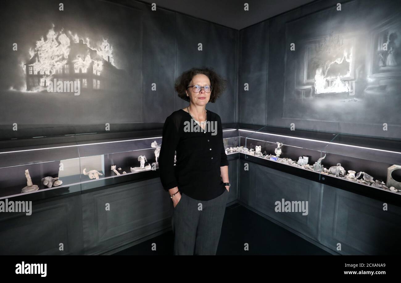 Neubrandenburg, Germany. 30th Sep, 2020. Elke Pretzel stands in the Kunstsammlung in the 'Brandzimmer', an exhibition with remains of the historical art collection that disappeared in the turmoil of war at the beginning of April 1945. On 1 October 2020, the art historian will receive this year's Annalise-Wagner-Prize for her work on the historical Neubrandenburg Art Collection. Credit: Bernd Wüstneck/dpa-Zentralbild/dpa/Alamy Live News Stock Photo
