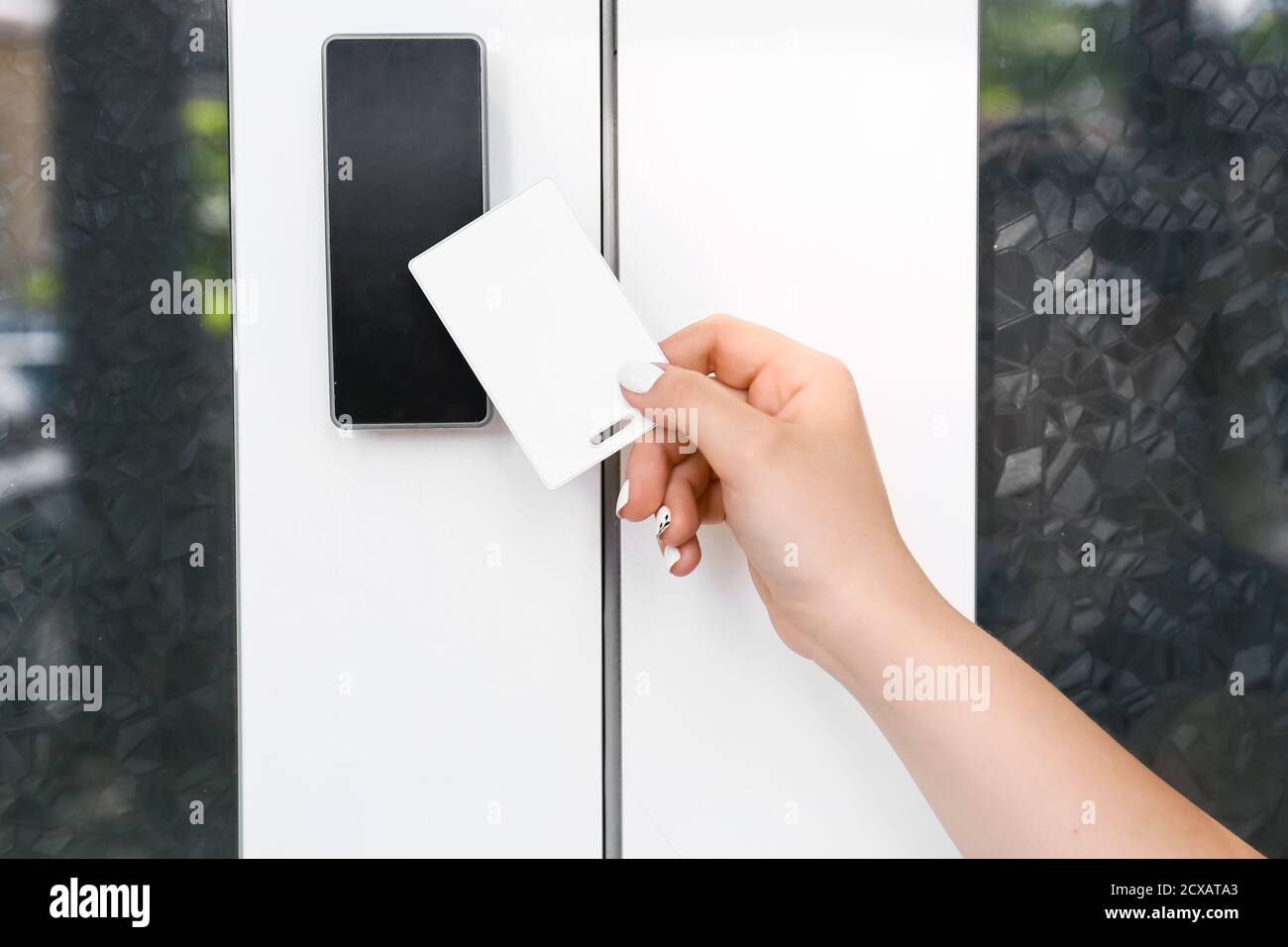 Woman using card to open door outdoors Stock Photo Alamy