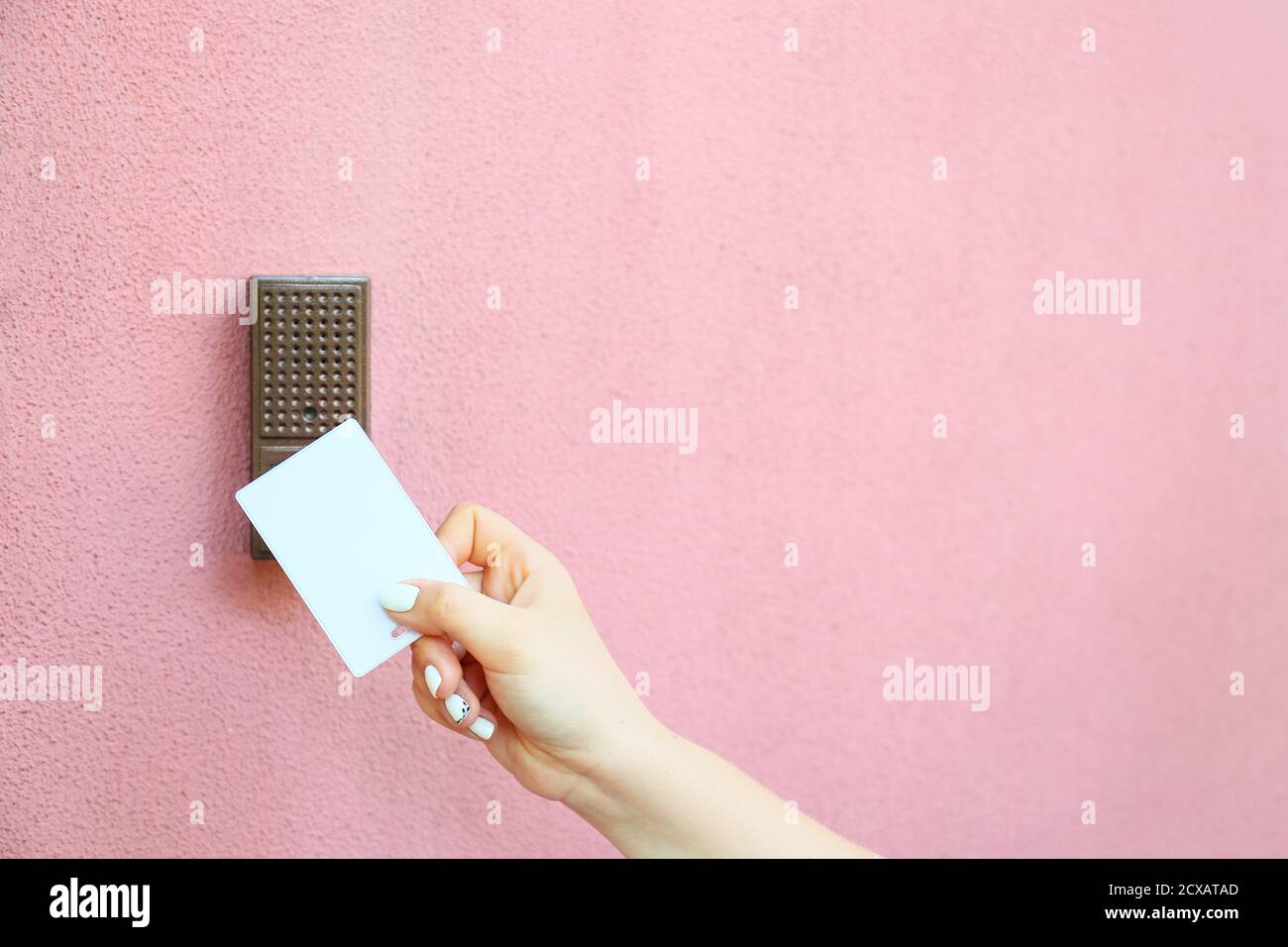Woman using card to open door outdoors Stock Photo Alamy
