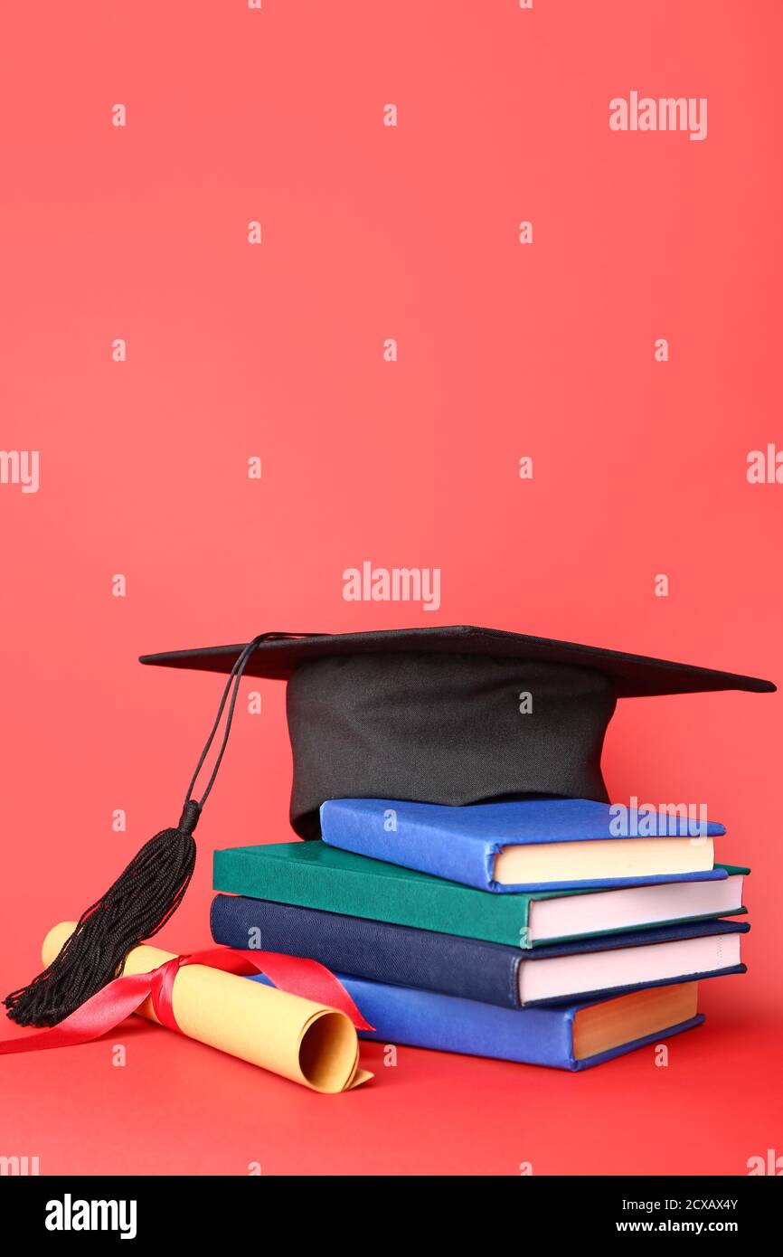 Graduation hat, diploma and books on color background Stock Photo - Alamy