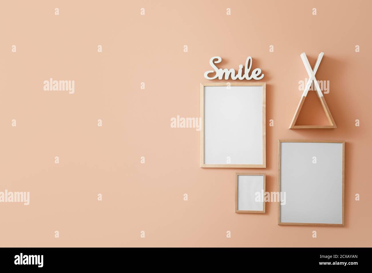 Blank photo frames hanging on color wall Stock Photo - Alamy
